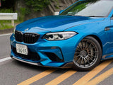 Blue BMW F87 M2 front corner showing the Paragon brake kit behind the wheel